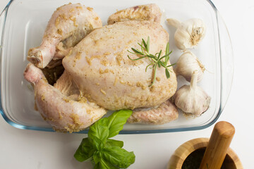 Fresh, marinated chicken with garlic, ready for frying. White background