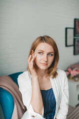 Fototapeta premium Beautiful woman with cosmetic patch under eye
