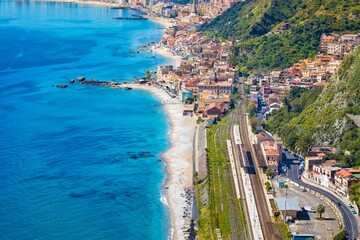 Fototapeta premium Aerial view of Taormina-Giardini station and Giardini Naxos, comune in Messina on Sicily Island, Italy.