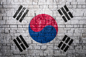 National flag of South Korea on brick  wall background.The concept of national pride and symbol of the country. Flag  banner on  stone texture background.