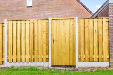 Obraz na płótnie Canvas New wooden fence construction with door