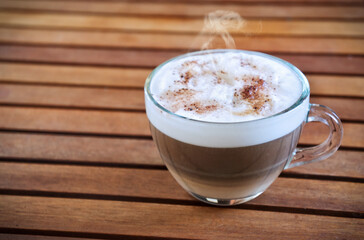 Cappuccino in transparent cup with copy space