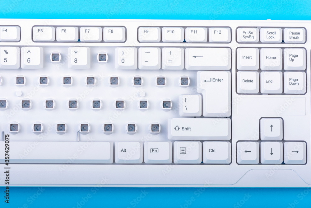 Fototapete keyboard without some keys. white keyboard on blue background. top view. close up