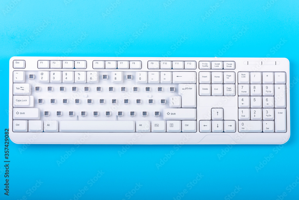 Fototapete keyboard without some keys. white keyboard on blue background. top view. close up