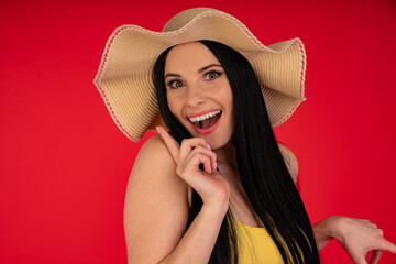 Travel concept - Close up Portrait young beautiful attractive girl wtih trendy hat and smiling. Red Background. Copy space.
