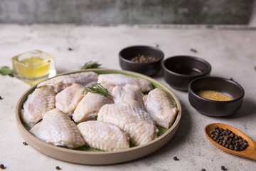 Raw chicken wings, meat with ingredients for cooking