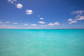 Tropical sea under the blue sky. Exotic seascape, crystal clear ocean water with endless view over the horizon
