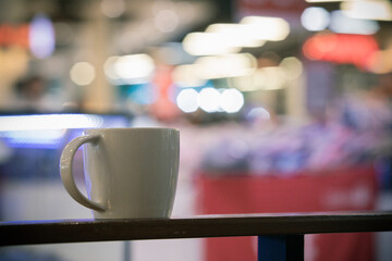 White coffee cup with street light bokeh,A cup of coffee in the cafe