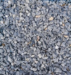 Grey granite gravel texture background. Grey ground stone rubble background of many small stones
