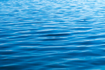 Naklejka premium Expanse of water, surface, waves, natural blue background