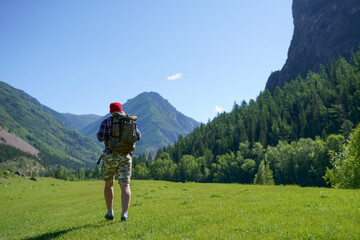 Fototapeta premium hiking, hike, hiker, mountains, men, trekking, mountain, walking, active, activity, adventure, altai, altay, back, backpack, backpacker, beautiful, blue, climbing, day, extreme, forest, freedom, grass