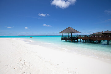 Amazing tropical over water bungalow resort on the beach. Luxury vacation, summer holiday beach landscape with copy space. White sand and blue sea sky, turquoise lagoon for travel template