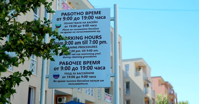 Pool Working Hours Sign And Cleaning Procedures, Rules Written In Bulgarian, English and Russian. Close Up View - DCi 4K Video
