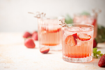 Refreshing summer drink with strawberry slices in glasses on white background