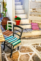 Traditional Greece. Typical street taverns (bars)  with cute wooden chairs .  Greece. Naxos island, Cycades.