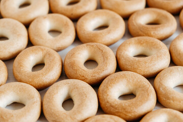 Drying or mini round bagels on a white wooden background. Copy, empty space for text