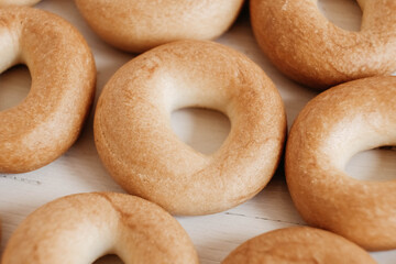Drying or mini round bagels on a white wooden background. Copy, empty space for text