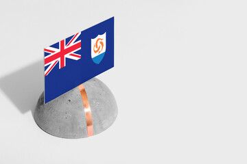 Anguilla flag tagged on rounded stone. White isolated background. Side view minimal national...