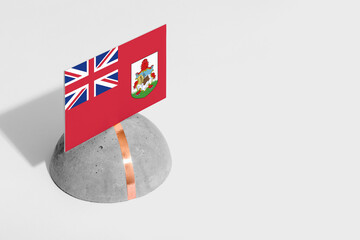 Bermuda flag tagged on rounded stone. White isolated background. Side view minimal national concept.