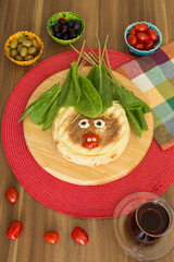 The cheese and sausage toast on the wooden plate for breakfast with tomatoes and olive.