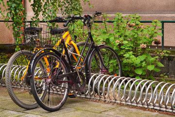 Modern Parking lot with Bicycles near an apartment red brick building with large number of bicycles. Eco-friendly and sports transport in the city.