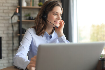 Freelance operator talking with headsets and consulting clients from home office.