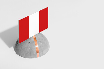 Peru flag tagged on rounded stone. White isolated background. Side view minimal national concept.