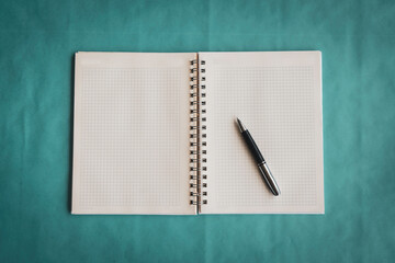 Top view of open notebook and pen with vintage background