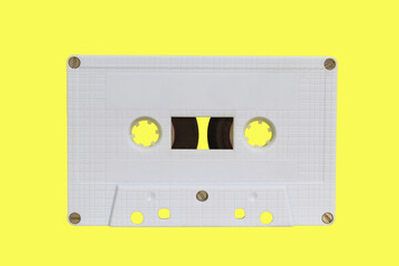 Obraz premium White audio cassette isolated on yellow background. Old vintage Cassette tape 