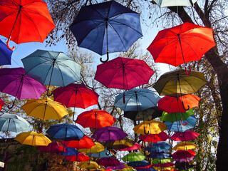 Fototapeta na wymiar Alley of Soaring Umbrellas also known as Umbrella Sky, multicolored street installation in Tashkent, Uzbekistan