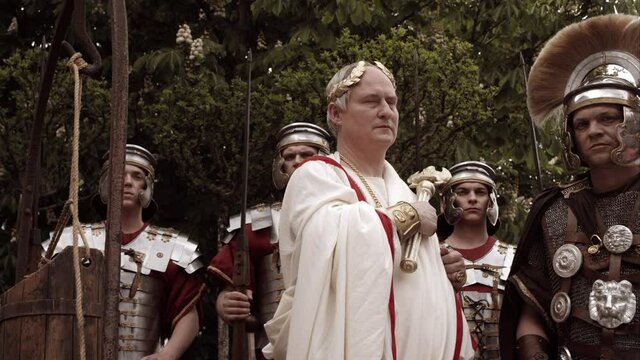 Emperor Standing Outside With Soldiers Holds Out Scepter And Gives An Order