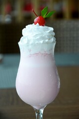 delicious strawberry milkshake with red chery as a garnish