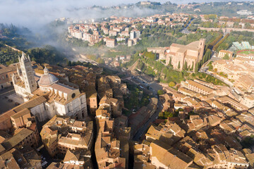 aerial view of the city of Siena with the fog Tuscany