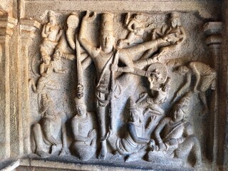 Bas relief rock cut sculptures of gods, people and animals are carved prominently in the monolithic...