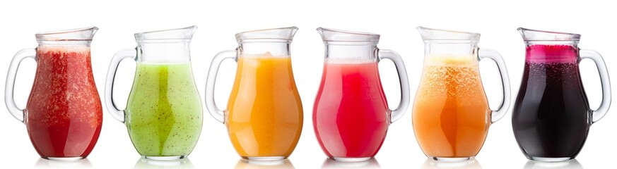Smoothies of freshly pressed juices in glass pitchers, isolated w clipping paths - obrazy, fototapety, plakaty