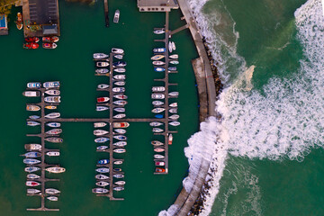 Fototapeta na wymiar Aerial view of a protected marina with boats near Strand, South Africa