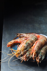 Giant Raw fresh Tiger Prawns in the plate over stone background