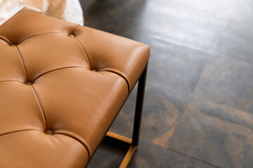 closeup of detail leather sofa color tone with wooden floor background