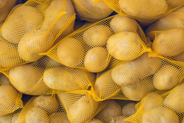 Fresh potatoes in market packed in nets