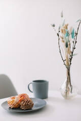 Cup of coffee with marshmallows and flowers on the table. Romantic morning. Tasty breakfast. Flat lay, top view, copy space.