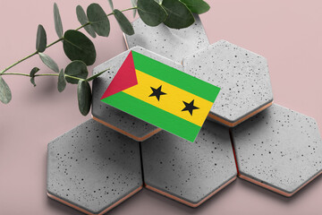 Sao Tome And Principe flag on hexagon stylish stones. Pink copy space background. Flat lay, top...