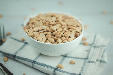 Roasted peanuts in white bowl