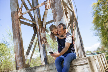 Father and daughter taking selfie outdoor. Copy space. Lifestyle concept.