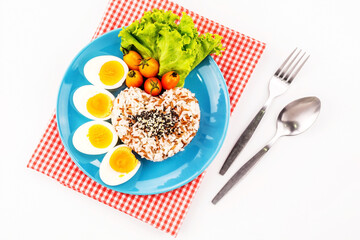 Boiled eggs with rice on blue plate