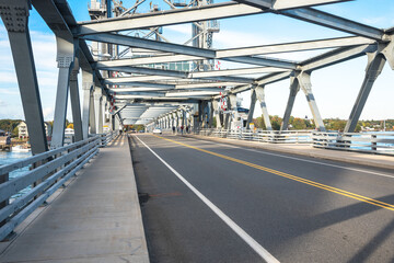 Steel vertical ift bridge with walkways on both sides of the road on a clear autumn day. Portsmouth, NH, USA.