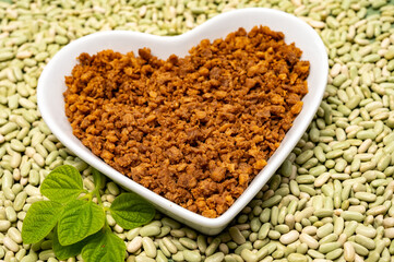 Love vegan and vegetarian food concept, plant based minced meat in heart shaped plate on soya beans background