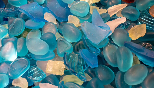 Colorful gemstones on a beach. Polish textured sea glass and