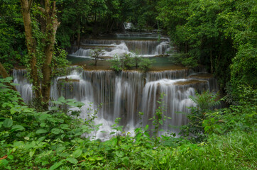 Beautiful natural landscape scene of waterfall in rain forest with green trees in long exposure photography