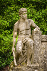 Fototapeta na wymiar Sculpture of a naked man in a city Park