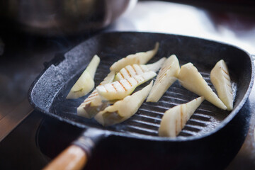 Grilled pear slices in a pan